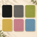 Double-layer EVA cat litter mats in black, gray, green, yellow, pink and blue on a warm cream background