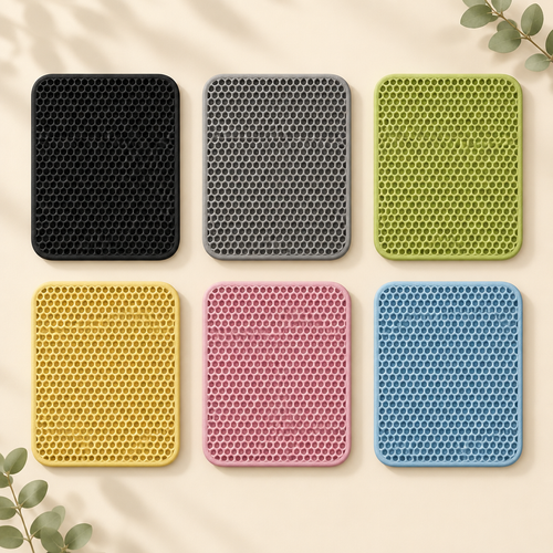 Double-layer EVA cat litter mats in black, gray, green, yellow, pink and blue on a warm cream background